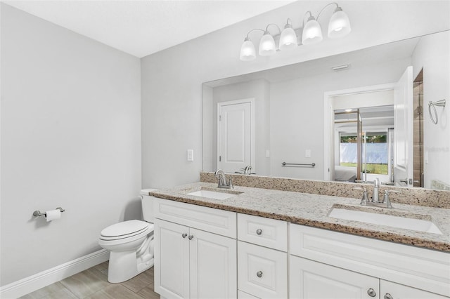 16380 SE 84th Ct, Summerfield, FL 34491 - ensuite bathroom with toilet, baseboards, a sink, and ensuite bath