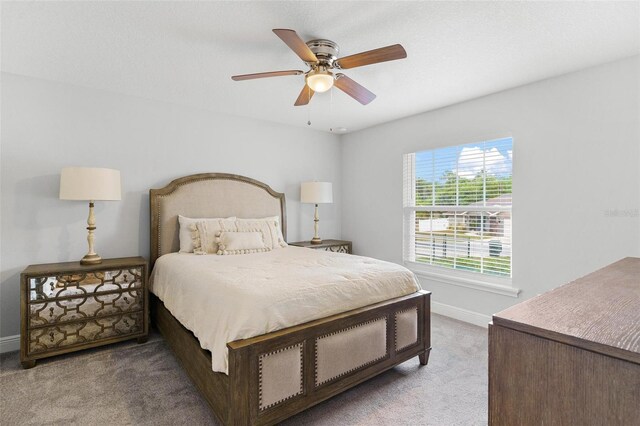 16380 SE 84th Ct, Summerfield, FL 34491 - bedroom with baseboards, ceiling fan, and carpet