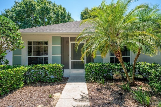 4386 Sambourne St, Clermont, FL 34711 - property entrance with a shingled roof and stucco siding