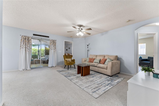 4386 Sambourne St, Clermont, FL 34711 - living area with baseboards, arched walkways, a ceiling fan, and plenty of natural light