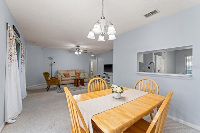 4386 Sambourne St, Clermont, FL 34711 - dining space featuring ceiling fan with notable chandelier, baseboards, visible vents, and light colored carpet