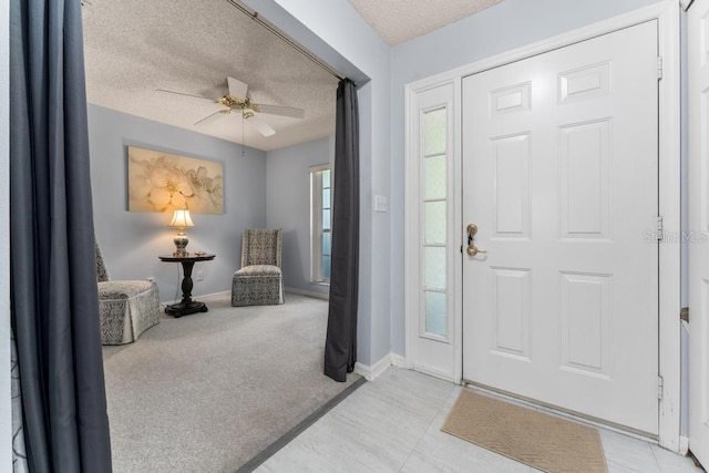 4386 Sambourne St, Clermont, FL 34711 - carpeted entrance foyer featuring a textured ceiling, a ceiling fan, and baseboards
