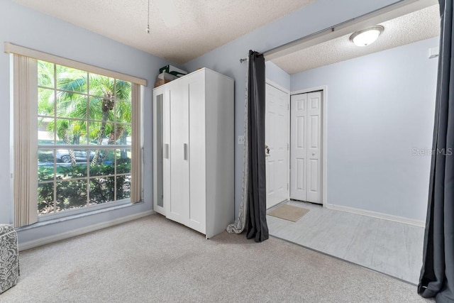 4386 Sambourne St, Clermont, FL 34711 - unfurnished bedroom with carpet floors, baseboards, and a textured ceiling