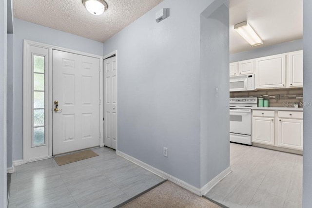 4386 Sambourne St, Clermont, FL 34711 - foyer entrance featuring a textured ceiling and baseboards
