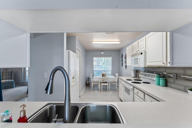 4386 Sambourne St, Clermont, FL 34711 - kitchen with a sink, white appliances, light countertops, white cabinetry, and visible vents