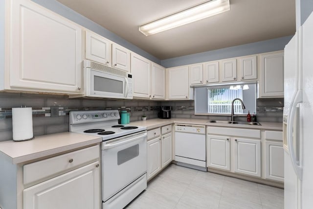 4386 Sambourne St, Clermont, FL 34711 - kitchen featuring white cabinets, backsplash, light countertops, a sink, and white appliances