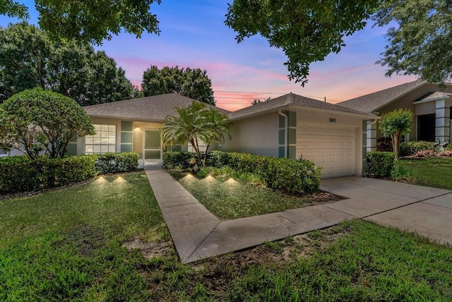 4386 Sambourne St, Clermont, FL 34711 - ranch-style home featuring stucco siding, a front lawn, concrete driveway, and a garage