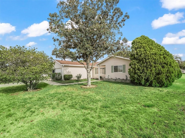 view of front facade featuring a front lawn and an attached garage