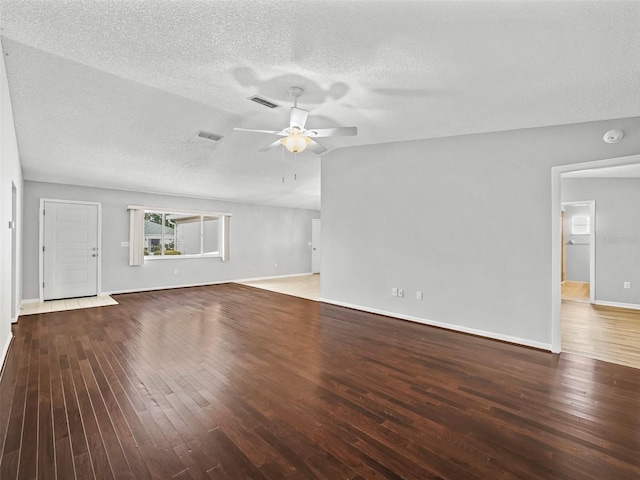 unfurnished living room featuring a ceiling fan, hardwood / wood-style floors, a textured ceiling, and baseboards