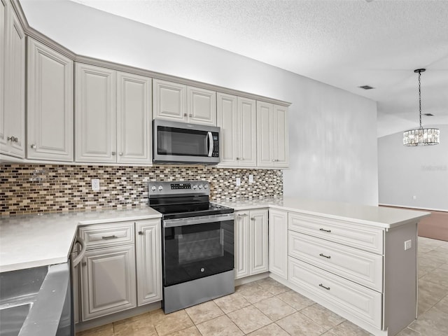kitchen featuring appliances with stainless steel finishes, a peninsula, tasteful backsplash, light countertops, and a chandelier