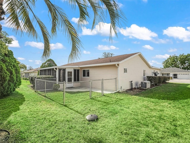 back of property featuring a sunroom, a gate, and central air condition unit