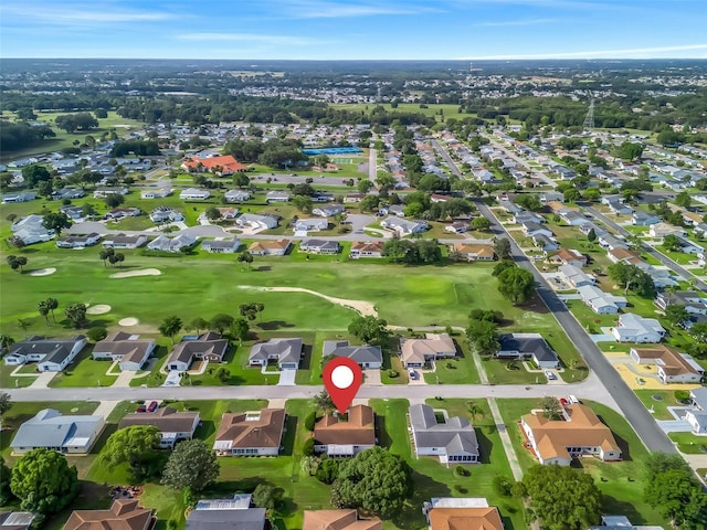 aerial overview of property's location with nearby suburban area and a golf club