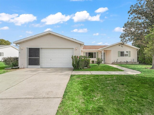 ranch-style house with driveway, an attached garage, and a front lawn