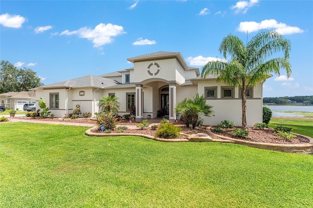 1111 Myrtle Breezes Ct, Fruitland Park, FL 34731 - mediterranean / spanish-style home with stucco siding, a front yard, and a water view