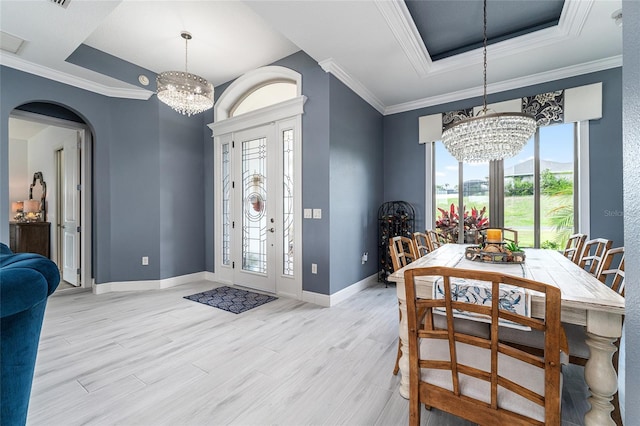 1111 Myrtle Breezes Ct, Fruitland Park, FL 34731 - dining space with a chandelier, a tray ceiling, plenty of natural light, and ornamental molding