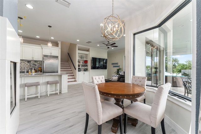1111 Myrtle Breezes Ct, Fruitland Park, FL 34731 - dining area featuring a chandelier, ornamental molding, stairway, recessed lighting, and light wood finished floors