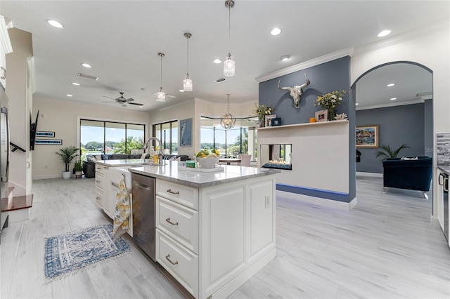 1111 Myrtle Breezes Ct, Fruitland Park, FL 34731 - kitchen with dishwasher, ornamental molding, baseboards, recessed lighting, and white cabinetry