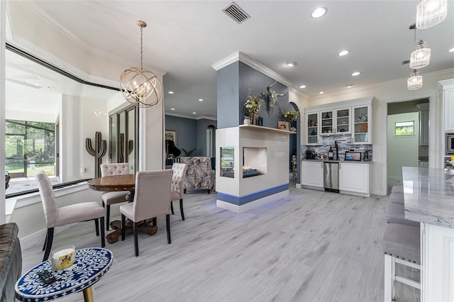 1111 Myrtle Breezes Ct, Fruitland Park, FL 34731 - dining space with ornamental molding, light wood finished floors, a chandelier, recessed lighting, and baseboards
