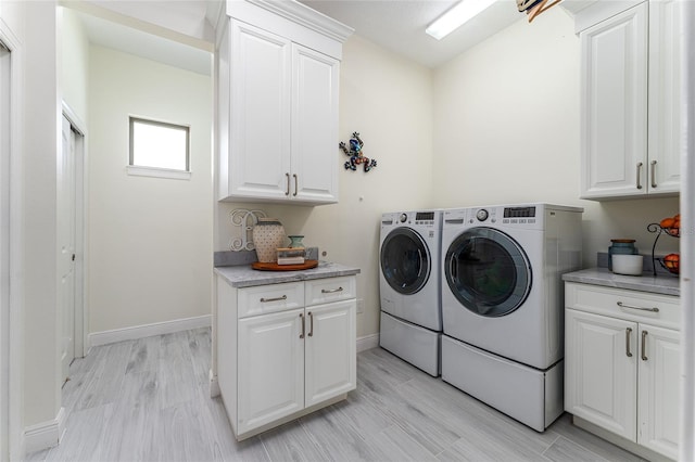 1111 Myrtle Breezes Ct, Fruitland Park, FL 34731 - laundry area with cabinet space, independent washer and dryer, baseboards, and light wood finished floors