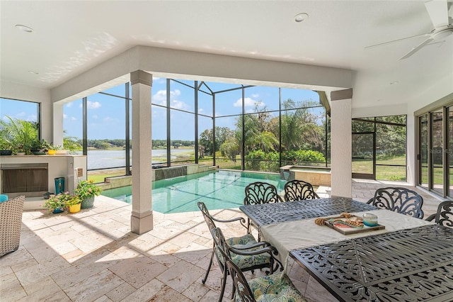 1111 Myrtle Breezes Ct, Fruitland Park, FL 34731 - view of swimming pool featuring ceiling fan, a patio area, a water view, a lanai, and a pool with connected hot tub