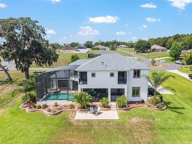 1111 Myrtle Breezes Ct, Fruitland Park, FL 34731 - rear view of property featuring a patio, a lawn, stucco siding, and a pool with connected hot tub