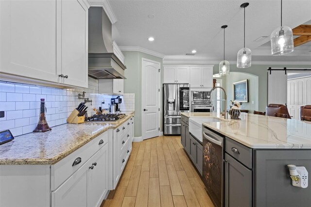 16200 E Shirley Shores Rd, Tavares, FL 32778 - kitchen with custom range hood, stainless steel appliances, a barn door, gray cabinetry, and a sink