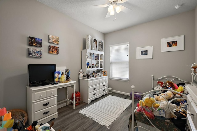 456 Winter Solstice Ln, Mount Dora, FL 32757 - bedroom featuring a textured ceiling, baseboards, dark wood-type flooring, and a ceiling fan
