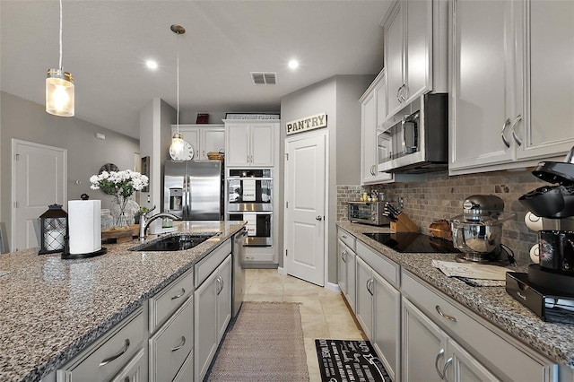 456 Winter Solstice Ln, Mount Dora, FL 32757 - kitchen featuring hanging light fixtures, a sink, visible vents, appliances with stainless steel finishes, and decorative backsplash