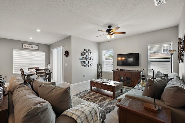 456 Winter Solstice Ln, Mount Dora, FL 32757 - living room featuring a ceiling fan, recessed lighting, a textured ceiling, baseboards, and visible vents