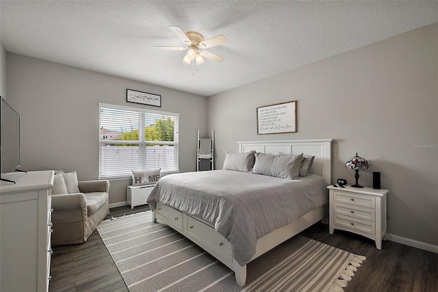 456 Winter Solstice Ln, Mount Dora, FL 32757 - bedroom with a textured ceiling, dark wood-style flooring, baseboards, and a ceiling fan