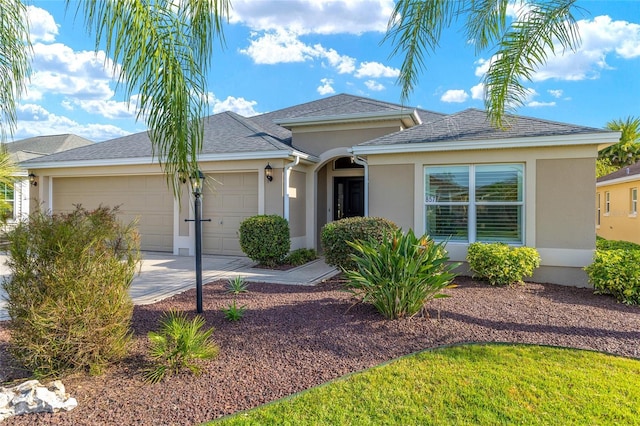 single story home featuring a garage, stucco siding, and driveway