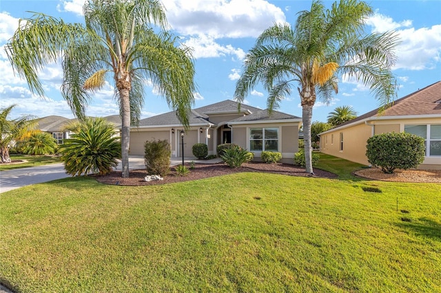view of front of home featuring concrete driveway, an attached garage, a front yard, and stucco siding