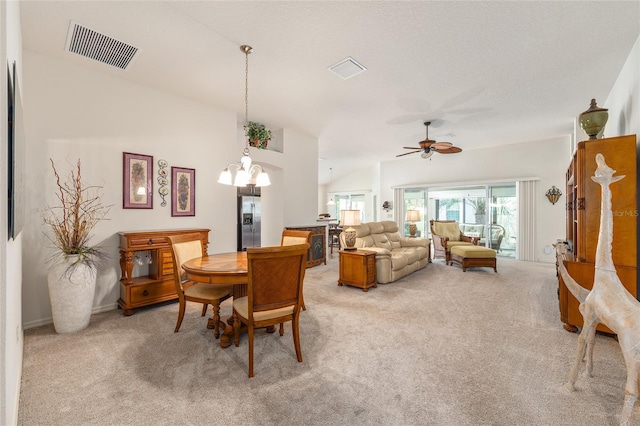 dining area with visible vents, ceiling fan with notable chandelier, and light carpet