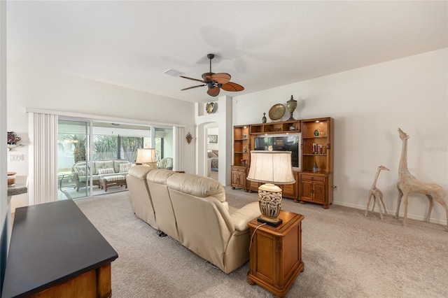 living area featuring visible vents, a ceiling fan, and light colored carpet