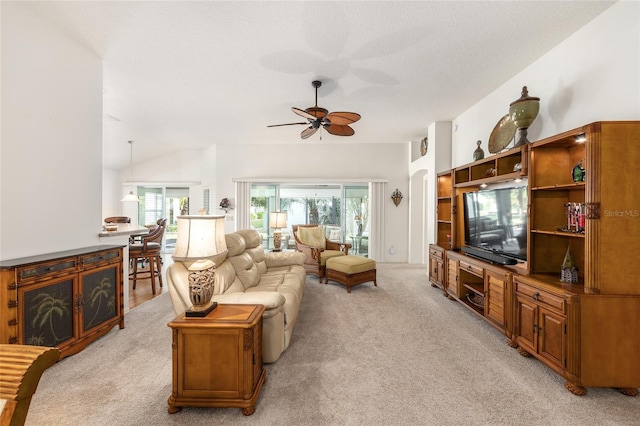 living area featuring light colored carpet, ceiling fan, and lofted ceiling