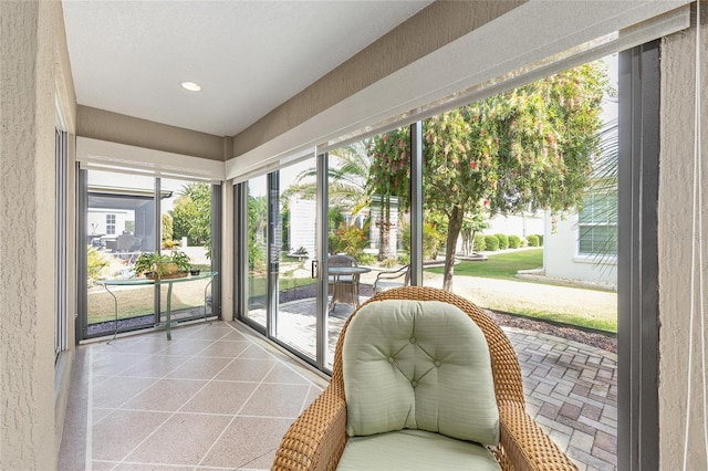 sunroom with recessed lighting and a textured wall