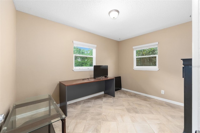 unfurnished office featuring baseboards