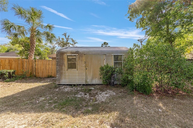view of shed featuring fence