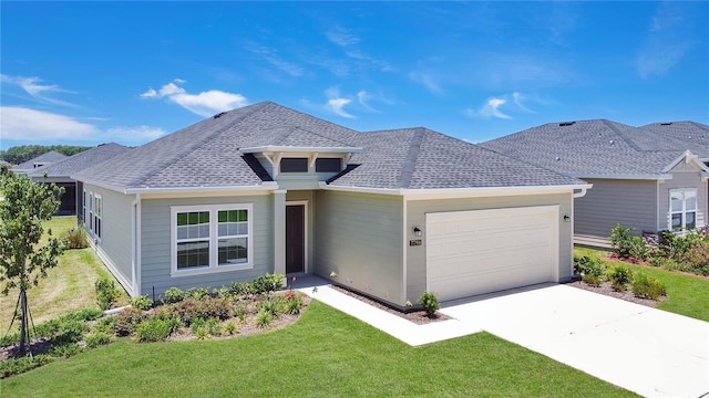 7796 SW 74th Loop, Ocala, FL 34481 - ranch-style house featuring a garage, driveway, a front lawn, and roof with shingles