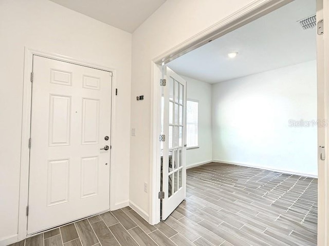 7796 SW 74th Loop, Ocala, FL 34481 - foyer entrance with baseboards, visible vents, and wood finish floors