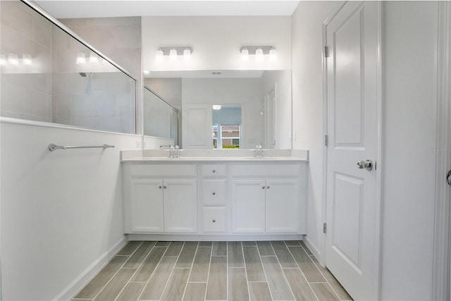 7796 SW 74th Loop, Ocala, FL 34481 - bathroom featuring a shower stall, baseboards, wood finish floors, and double vanity