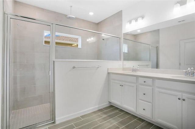 7796 SW 74th Loop, Ocala, FL 34481 - full bathroom featuring double vanity, visible vents, a shower stall, and a sink