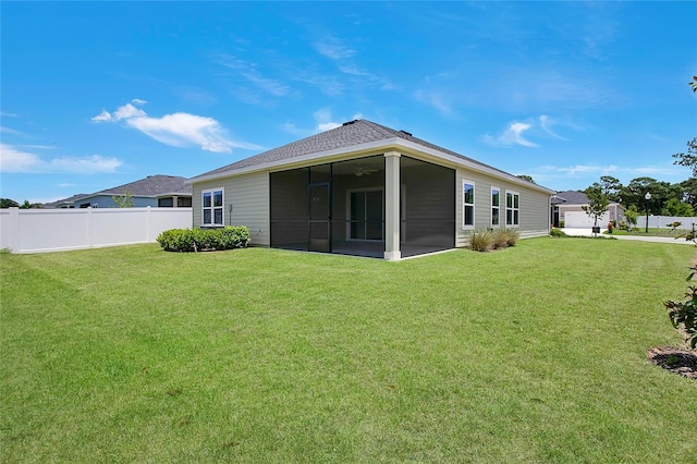7796 SW 74th Loop, Ocala, FL 34481 - back of house with a sunroom, a shingled roof, fence, and a lawn