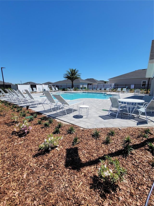 7796 SW 74th Loop, Ocala, FL 34481 - community pool with fence and a patio