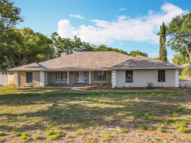 single story home with stucco siding and a front lawn