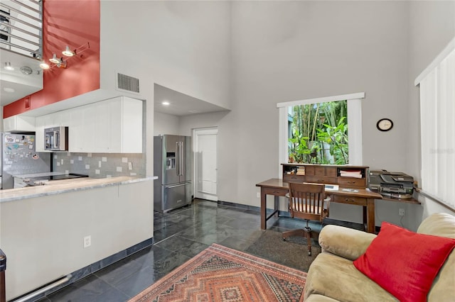9642 Bear Lake Rd, Apopka, FL 32703 - living room featuring baseboards, a high ceiling, and visible vents