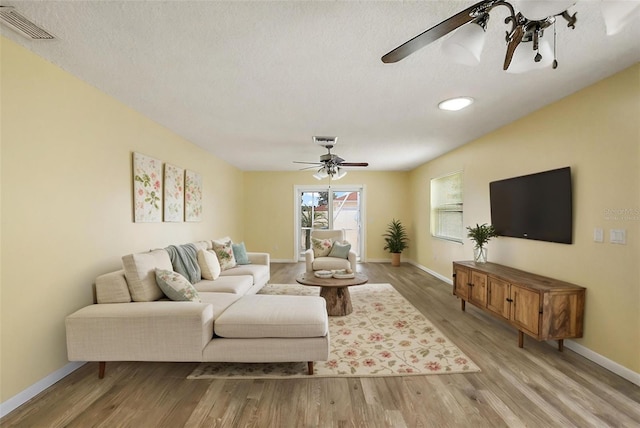 1323 Balboa Ct, The Villages, FL 32159 - living area featuring wood finished floors, ceiling fan, visible vents, and baseboards
