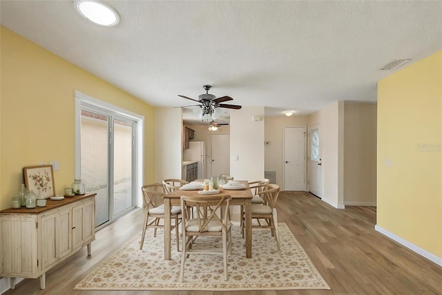 1323 Balboa Ct, The Villages, FL 32159 - dining space with baseboards, visible vents, ceiling fan, and light wood finished floors
