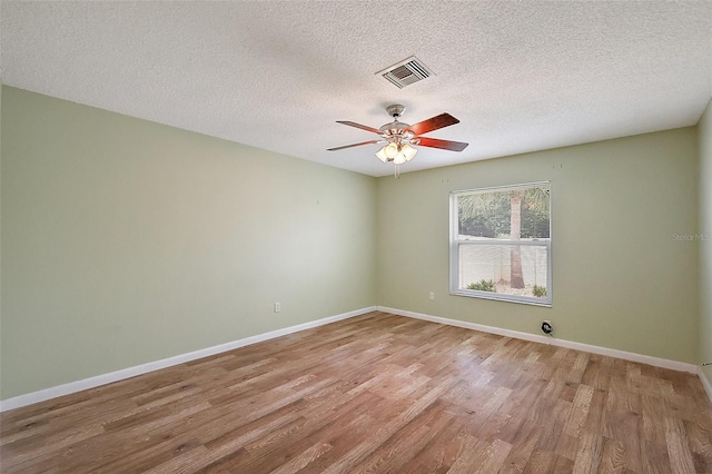 1323 Balboa Ct, The Villages, FL 32159 - unfurnished room featuring a textured ceiling, visible vents, baseboards, light wood-type flooring, and a ceiling fan