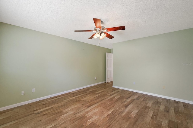 1323 Balboa Ct, The Villages, FL 32159 - empty room featuring a textured ceiling, wood finished floors, a ceiling fan, and baseboards